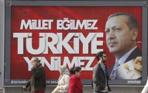 People walk past a poster for Erdogan's election campaign in Istanbul